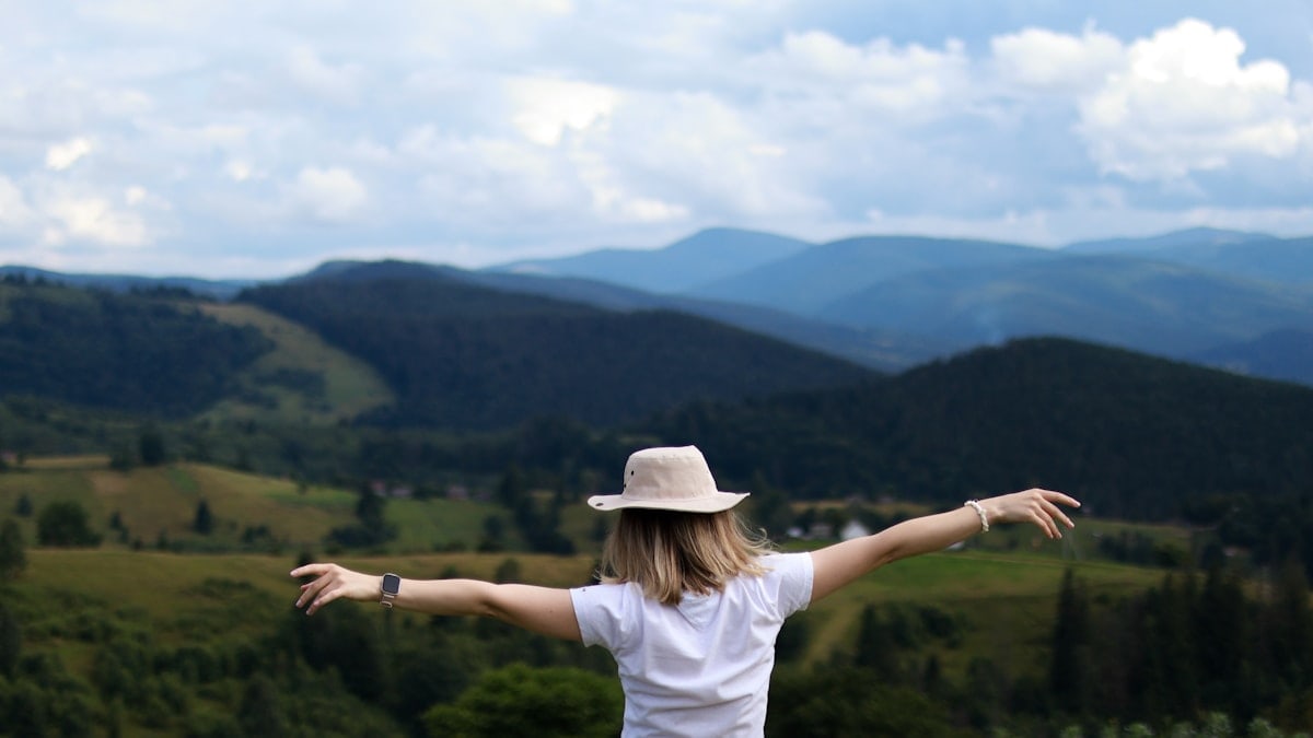 Happy woman high in the mountains